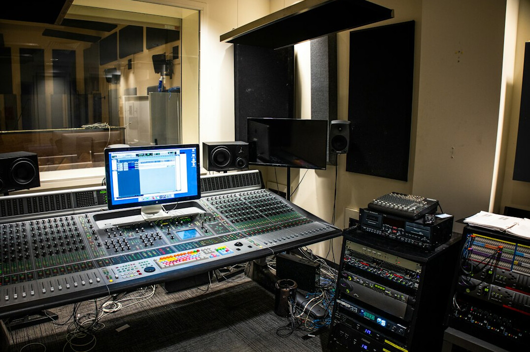 Television production control room with rows of monitors and mixing desks
